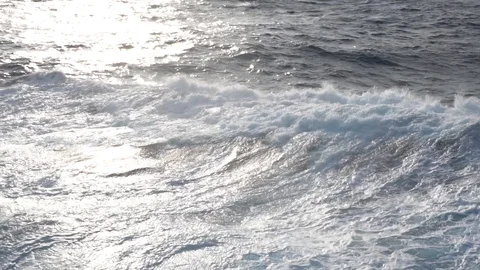 Splashes of sea waves with spray at sunset Stock Footage 115717050