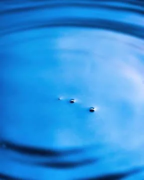 Splashes of water and blurry waves. Stock Photos