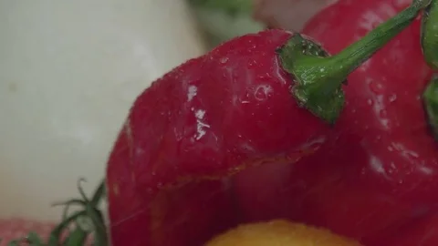 Splashes of water fall down on a fresh red pepper. Stock Footage 80447934