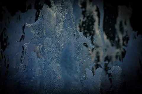 Splashes of water floating in the darkness Stock Photos