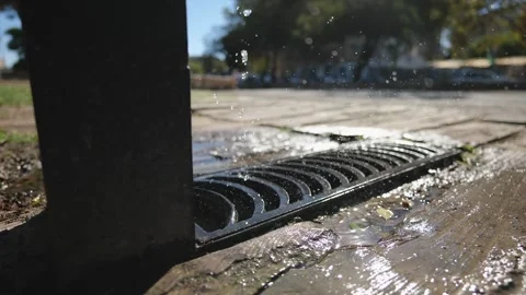Splashes of Water in the Rays of the Sun From an Outdoor Faucet on the Stre.. Stock Footage 287586708
