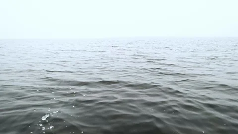 Splashes of water on the side of a fast moving boat on sea on a cloudy day Stock Footage 94485738