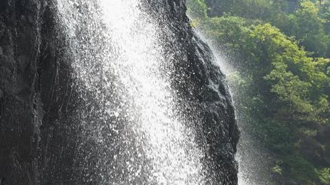 Splashes of water from the waterfall close up Stock Photos