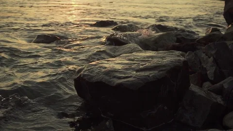 Splashes of water from a wave on a stony shore slow mo Stock Footage 81355069