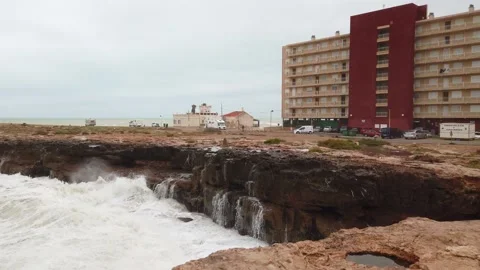 Splashes of water from the waves breaking on the stones Stock Footage 133809139