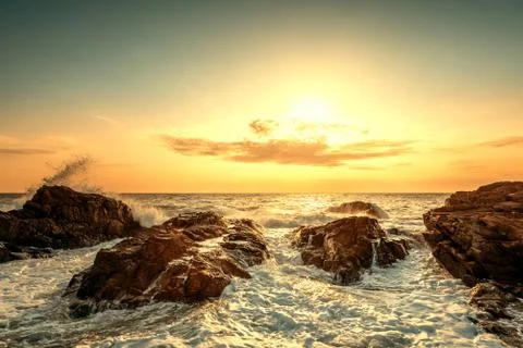 Splashes of wave at sunrise Stock Photos