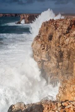 Splashes waves beat against the rocks. Stock Photos