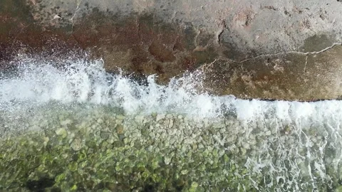 Splashes of waves crashing on stone Stock Footage 265790158