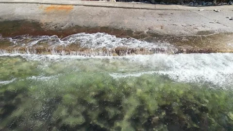 Splashes of waves crashing on stone Stock Footage 265790179