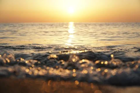 Splashes from the waves at sunset Stock Photos