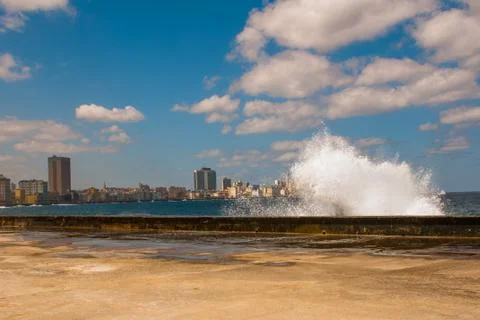 Splashes of waves .View from the Malecon promenade to the city. Cuba. Havana. Stock Photos