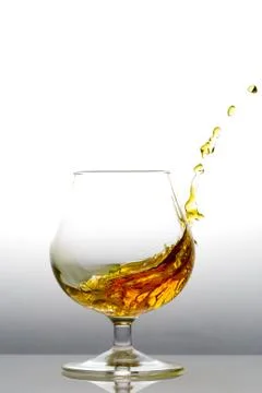 Splashing cognac Stock Photos