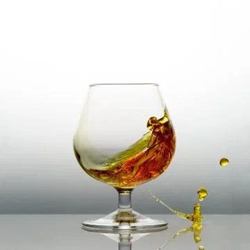 Splashing cognac Stock Photos