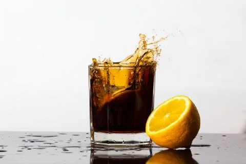 Splashing drink of cola Stock Photos