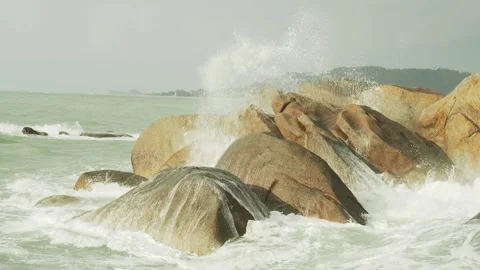 Splashing sea waves over big rocks Stock Footage 331428130
