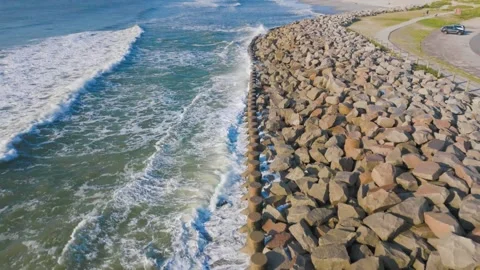 Splashing on the seawall. Stock Footage 283575392