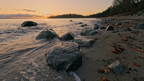 Splashing slow motion waves on sunrise with dramatic clouds Stock Footage 128408563