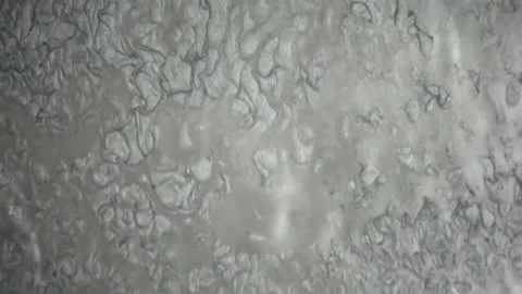 Splashing water droplets in slow motion close-up. High-speed liquid texture with Stock Footage 340450256