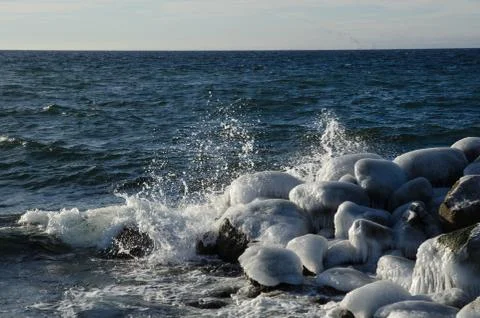 Splashing water at icy rocks Stock Photos