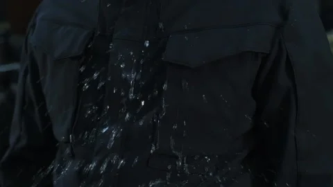 Splashing water on the jacket Stock Footage 154546612