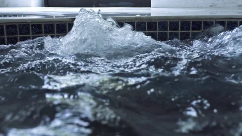 Splashing water in jacuzzi pool on spa center. Boiling water in jacuzzi tub in Stock Footage 106437249