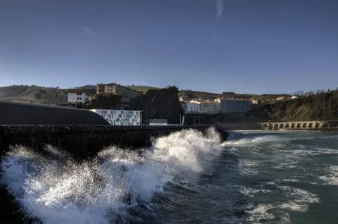 Splashing wave in to the wall Stock Photos