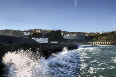 Splashing wave in to the wall Stock Photos