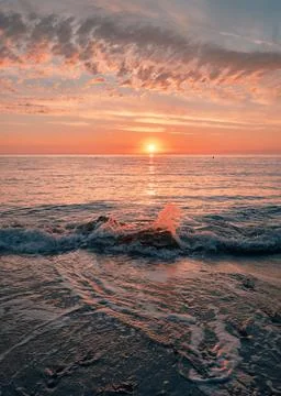 Splashing waves illuminated by sunlight Stock Photos