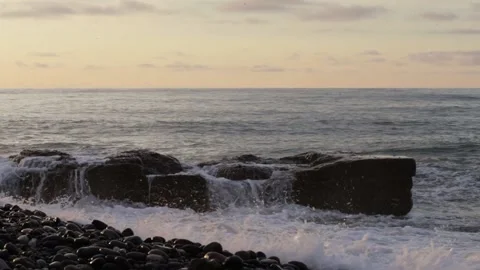 Splashing waves on the pebbly beach On the Sunset Stock Footage 237704186