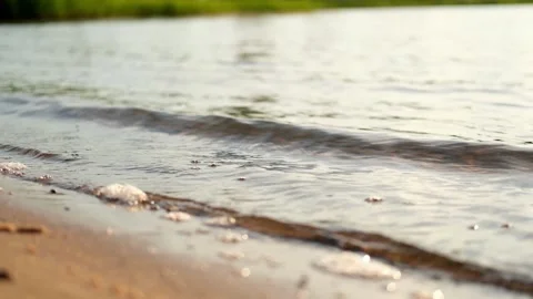 The splashing waves of the river at sunset. Sand, water, sun and fresh air. Stock Footage 282776054