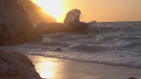 Splashing waves on the rocks of Myrtos beach in Kefalonia Greece at sunset Stock Footage 151305182