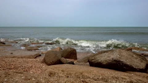 Splashing waves on rocky beach Stock Footage 153126313