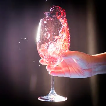 Splashing wine in glass Stock Photos