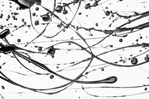 Splattered black paint making a complex abstract pattern on a white surface Stock Photos
