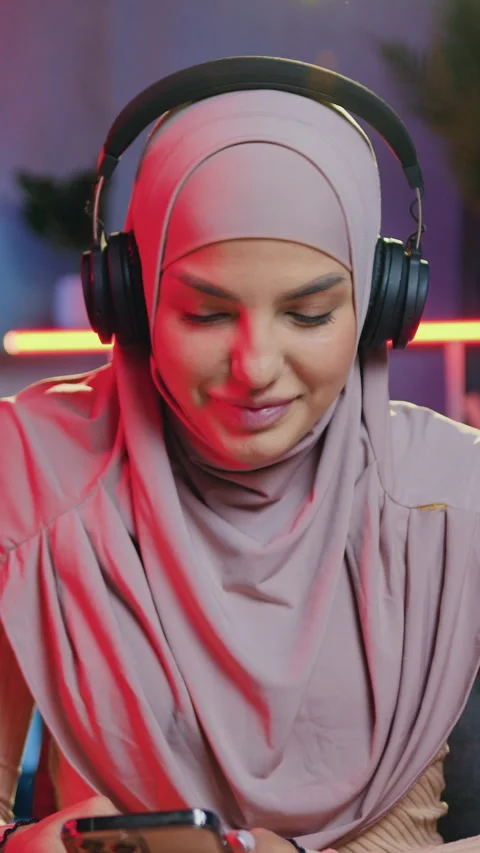 Splendid contented in good mood young muslim woman in traditional headscarf enjo Stock Footage 325213602