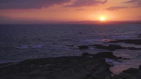 Splendid seascape with cloudy sky and sun setting into the Mediterranean sea Stock Footage 76988580