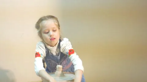 Splendid Six Year Blonde Girl is Working at a Pottery Wheel, Being Dressed in Stock Footage 59122942