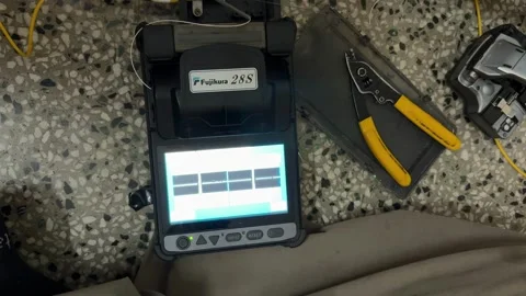 Splicing Fiber Optic Cable Using Fusion Splicer Machine for Network Installation Stock Footage 340958140