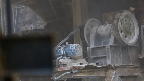 Splinters belt is rolling and dropping off gravels on the heap of rocks Stockbeeldmateriaal 75094932