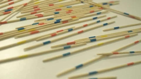 Splints of the micado game fall on a white shelf Stock Footage 127051880