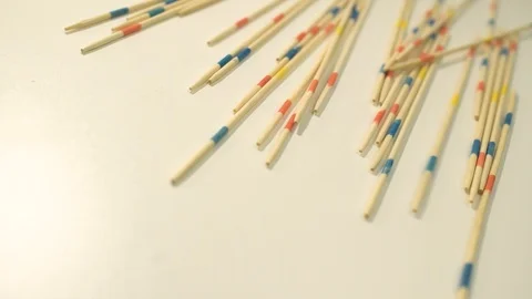 Splints of the micado game fall on a white shelf Stock Footage 127051882