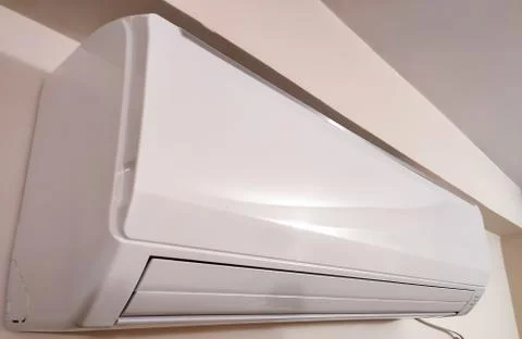 Split air conditioner on a white wall. Closeup image. Stock Photos