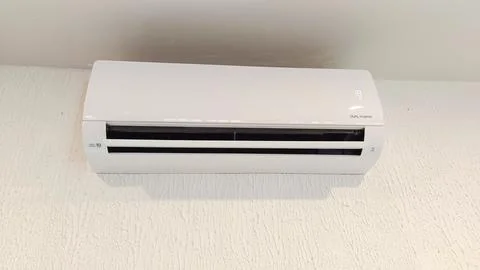 Split air conditioner on a white wall use when hot weather Foto stock