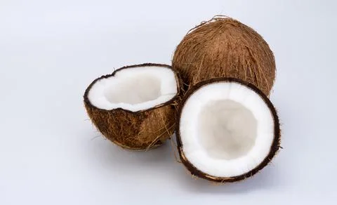Split and whole coconut on a white background. Coco, ripe palm fruit. Foto stock