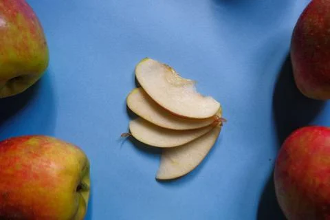 A split apple with a blue background, a perfect photo for a food flogger Stock Photos