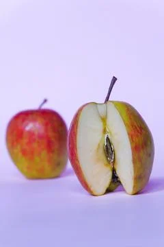 A split apple with a pink background, a perfect photo for a food flogger Stock Photos