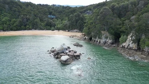 Split Apple Rock – Panning and Spinning Reveal of the Beach Stock Footage 303284230