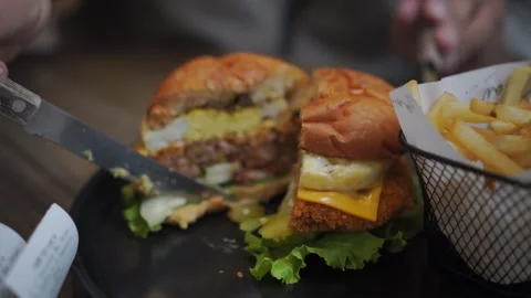 Split the burger with a knife and it's ready to eat. Stock Footage 320514901