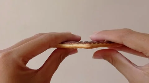 Split the chocolate cookie for sharing with friends Stock Footage 151025979