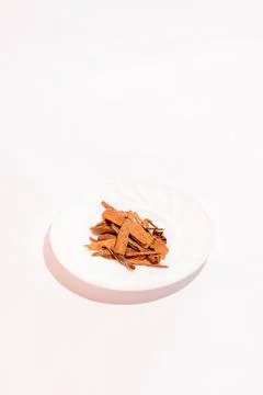 Split cinnamon for cooking stacked on white background. Pile of cinnamon on Stock Photos